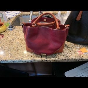 2 Dooney Bourke purses each with a long strap